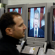 Yancey Wade, of San Francisco, watches U.S. President George W. Bush deliver the State of the Union address on a wall of televisions at a Best Buy store January 20, 2004 in San Francisco.